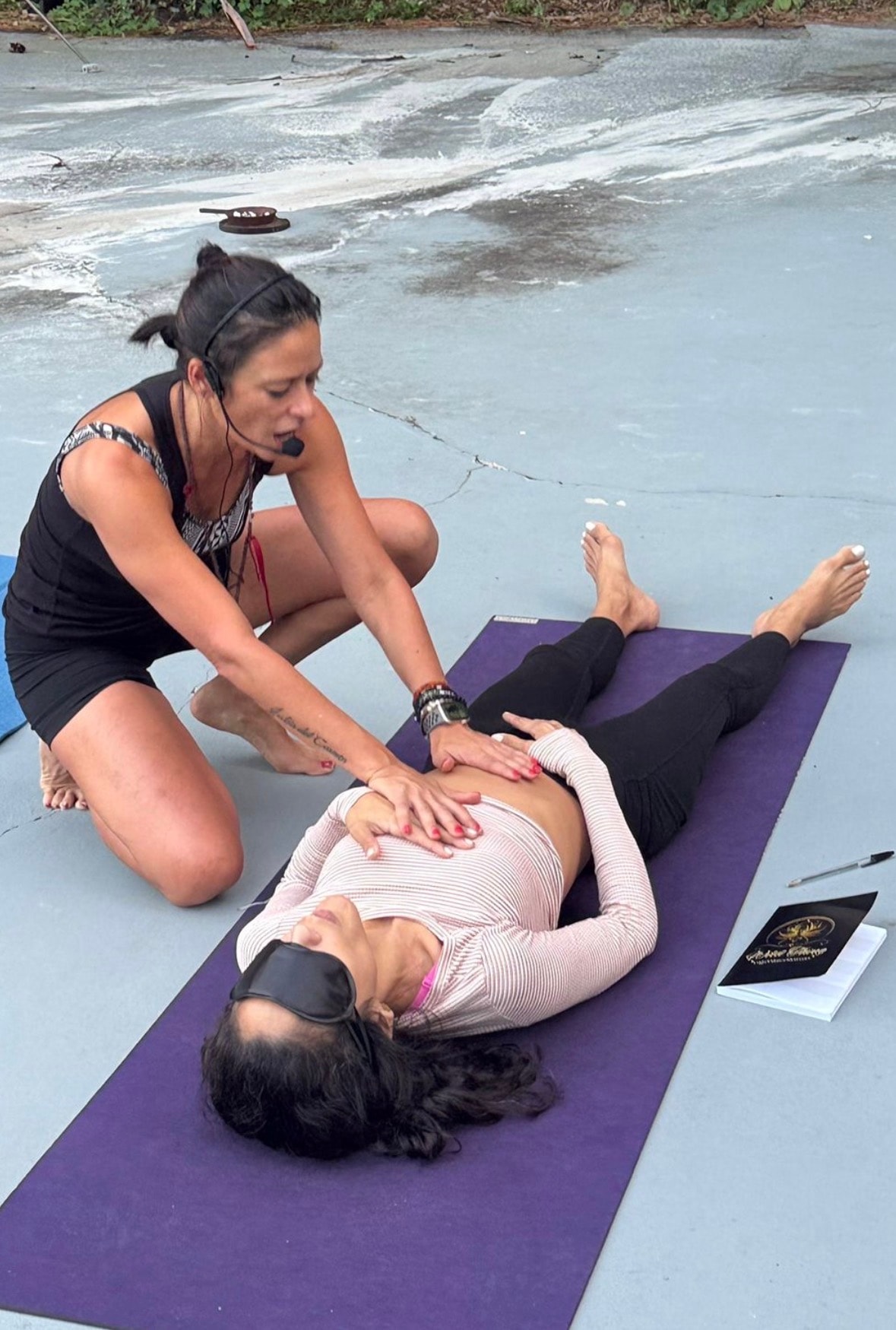 Yoga instructor guiding student outdoor class