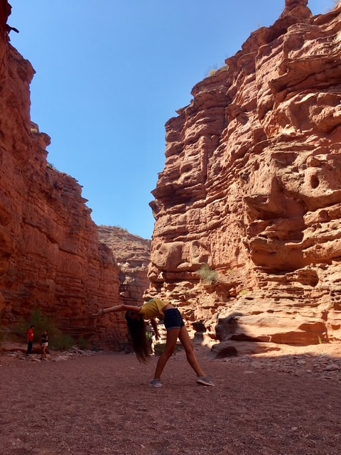 Julia doing a warrior pose inside Talampaya canyon